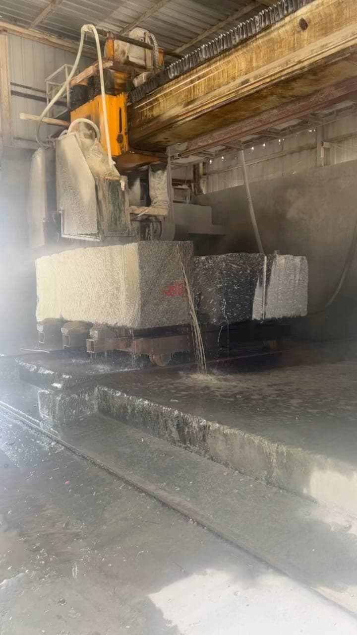 Large stone block being cut inside the factory