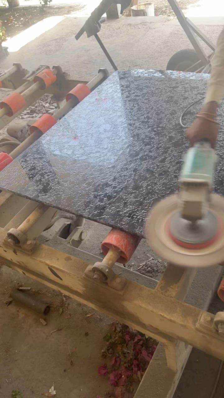 Craftsperson hand-finishing the surface of a stone slab